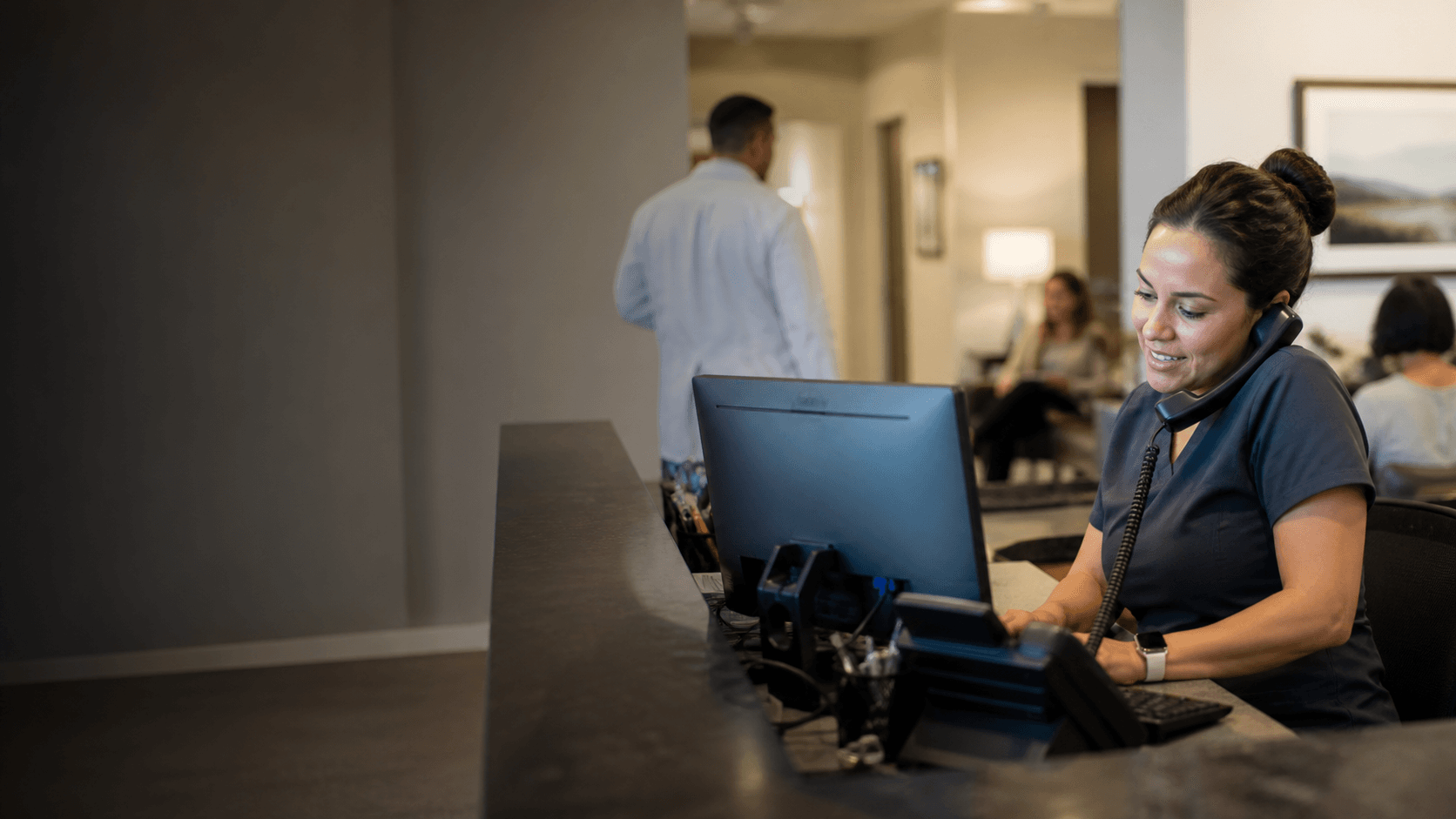 Clinic administrator handling calls at a local medical practice